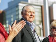 Washington State alumnus Keith Jackson smiles after raising the Cougar flag before the start of an  football game in 2014 at Martin Stadium in Pullman. Jackson, the down-home voice of college football during more than five decades as a broadcaster, died Friday, Jan. 12, 2018. He was 89.