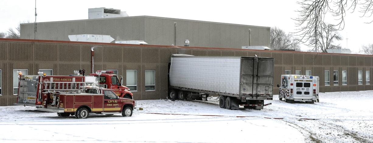 A semitrailer is embedded in the side of Lyle Public School Tuesday morning, Jan. 16, 2018 after it veered off a highway and crashed through the wall of the elementary school in Lyle, Minnesota. The semi left Highway 218 in Lyle after trying to avoid a car making a turn, striking it in the right rear of the vehicle.