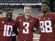 FILE - In this Sept. 9, 2017, file photo, Washington State defensive back Kirkland Parker (10), quarterback Tyler Hilinski (3) and wide receiver CJ Dimry (88) pose for a photo after an NCAA college football game against Boise State in Pullman, Wash. Hilinski has died from an apparent self-inflicted gunshot wound. The 21-year-old Hilinski was discovered in his apartment after he didn't show up for practice Tuesday, Jan. 16, 2018.