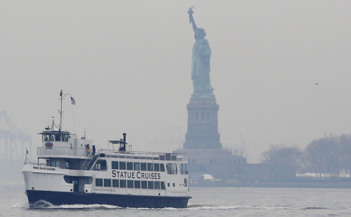 A Statue of Liberty and Ellis Island tour boat passes by the Statue of Liberty after dropping passengers off there, Monday, Jan. 22, 2018, in New York, after resuming service early Monday during the government shutdown. The Statue of Liberty and Ellis Island opened for visitors Monday, with New York state picking up the tab for the federal workers.