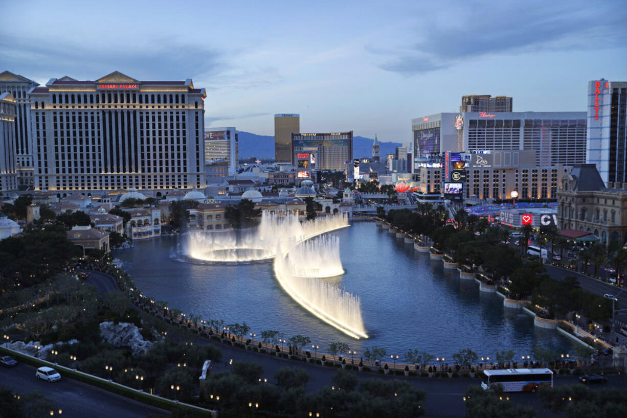 File - In this April 4, 2017, file photo, the fountains of Bellagio erupt along the Las Vegas Strip in Las Vegas. The union representing hotel workers in Las Vegas will ask casino-resort operators to give every housekeeper a 'panic button' as part of their new contracts. Leaders of the Culinary Union will bring the request to the bargaining table next month on behalf of 14,000 housekeepers who work on the Las Vegas Strip and the destination's downtown area. The push comes amid the #MeToo movement against sexual assault and harassment and is in line with ordinances recently approved in other cities.