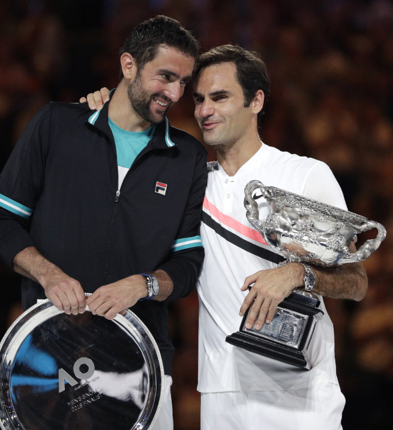 Switzerland's Roger Federer, right, talks with Croatia's Marin Cilic after he won their men's singles final at the Australian Open tennis championships in Melbourne, Australia, Sunday, Jan. 28, 2018.