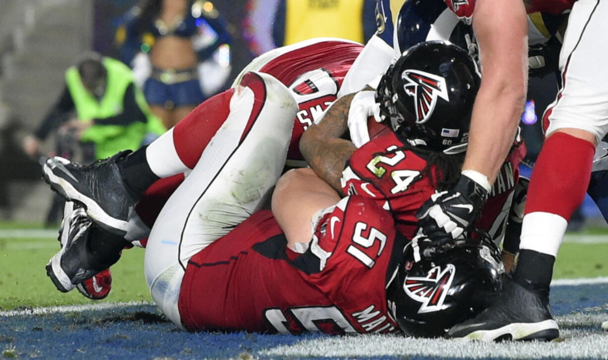 Atlanta Falcons running back Devonta Freeman (24) scores against the Los Angeles Rams during the first half of an NFL football wild-card playoff game Saturday, Jan. 6, 2018, in Los Angeles. (AP Photo/Mark J.