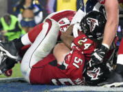 Atlanta Falcons running back Devonta Freeman (24) scores against the Los Angeles Rams during the first half of an NFL football wild-card playoff game Saturday, Jan. 6, 2018, in Los Angeles. (AP Photo/Mark J.