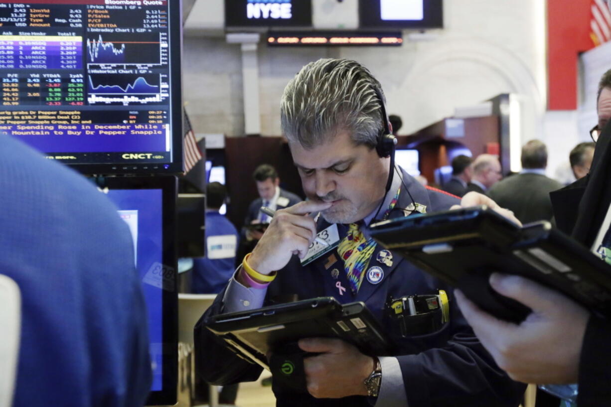 Trader John Panin works on the floor of the New York Stock Exchange, Monday, Jan. 29, 2018. The major U.S. stock indexes are down slightly in early trading Monday, as losses in technology companies outweighed gains elsewhere.