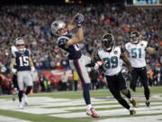 New England Patriots wide receiver Danny Amendola (80) catches a touchdown pass in front of Jacksonville Jaguars safety Tashaun Gipson (39) and linebacker Paul Posluszny (51) during the second half of the AFC championship NFL football game, Sunday, Jan. 21, 2018, in Foxborough, Mass. (AP Photo/David J.