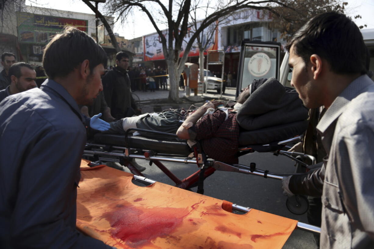 An injured man is moved onto a stretcher outside a hospital following a suicide attack in Kabul, Afghanistan, Saturday Jan. 27, 2018. A suicide car bomber killed at least 40 people and wounded about 140 more in an attack claimed by the Taliban on Saturday in Afghanistan's capital Kabul, authorities said.