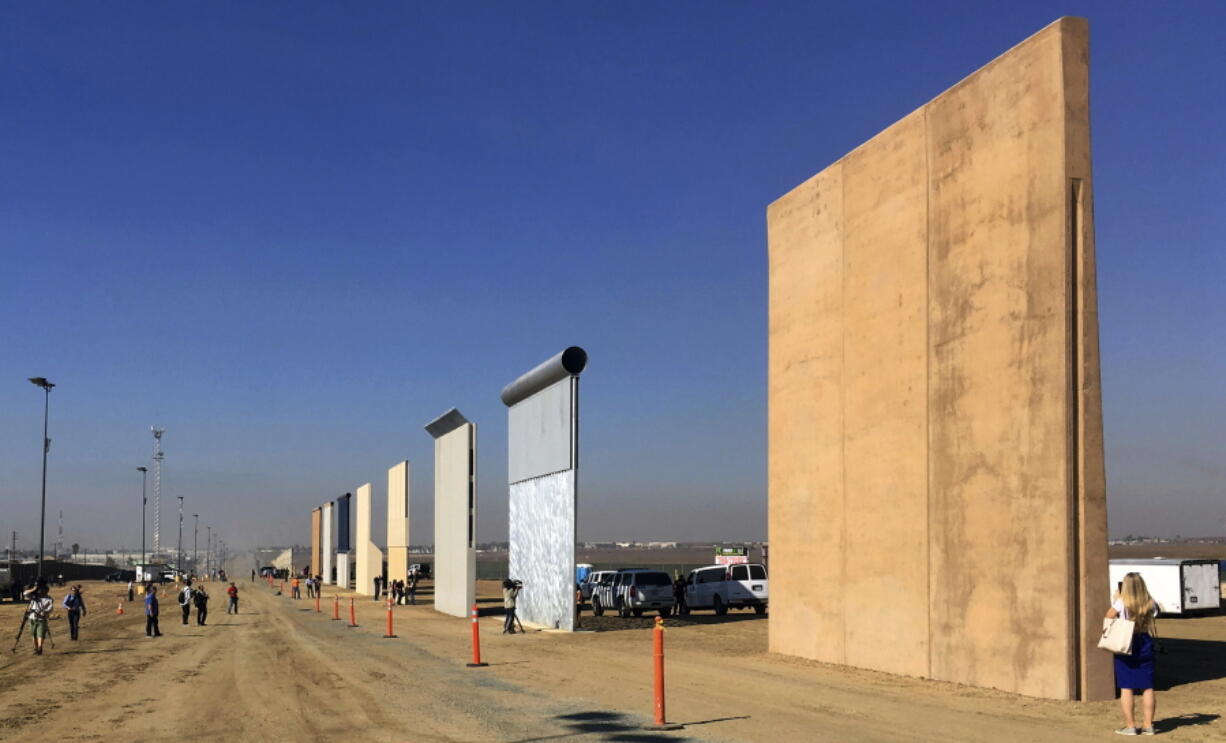 Prototypes of border walls are seen in San Diego on Oct. 26. A U.S. official says testing of prototypes of the proposed wall with Mexico found their heights should stop border crossers.