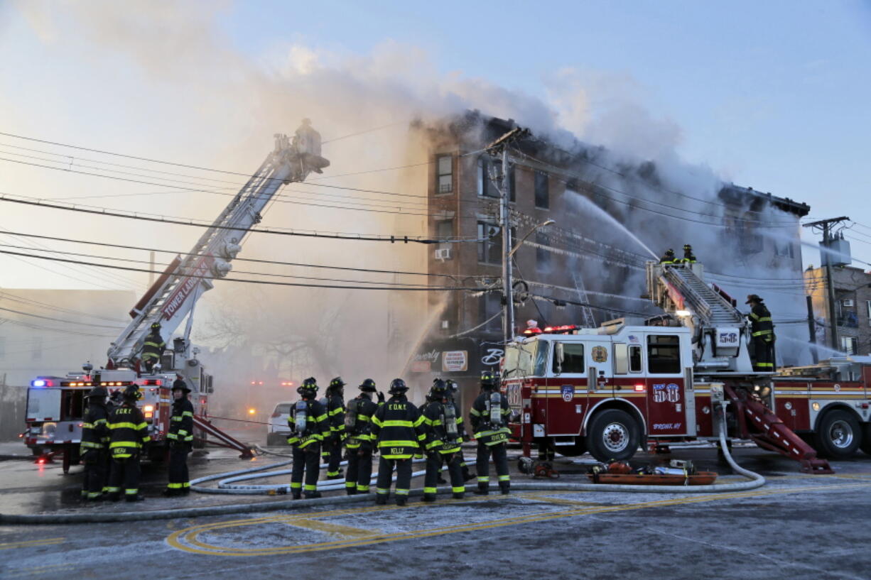 Firefighters work to contain a blaze in the Bronx section of New York on Tuesday.