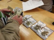 A customer purchases marijuana at Harborside marijuana dispensary earlier this year in Oakland, after voters in the state of California legalized recreational marijuana.