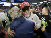 Arizona Cardinals head coach Bruce Arians, front right, hugs Seattle Seahawks head coach Pete Carroll, left, after an NFL football game, Sunday, Dec. 31, 2017, in Seattle.