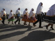 People in traditional dress arrive for a Mass celebrated by Pope Francis at O’Higgins Park in Santiago, Chile, on Tuesday.