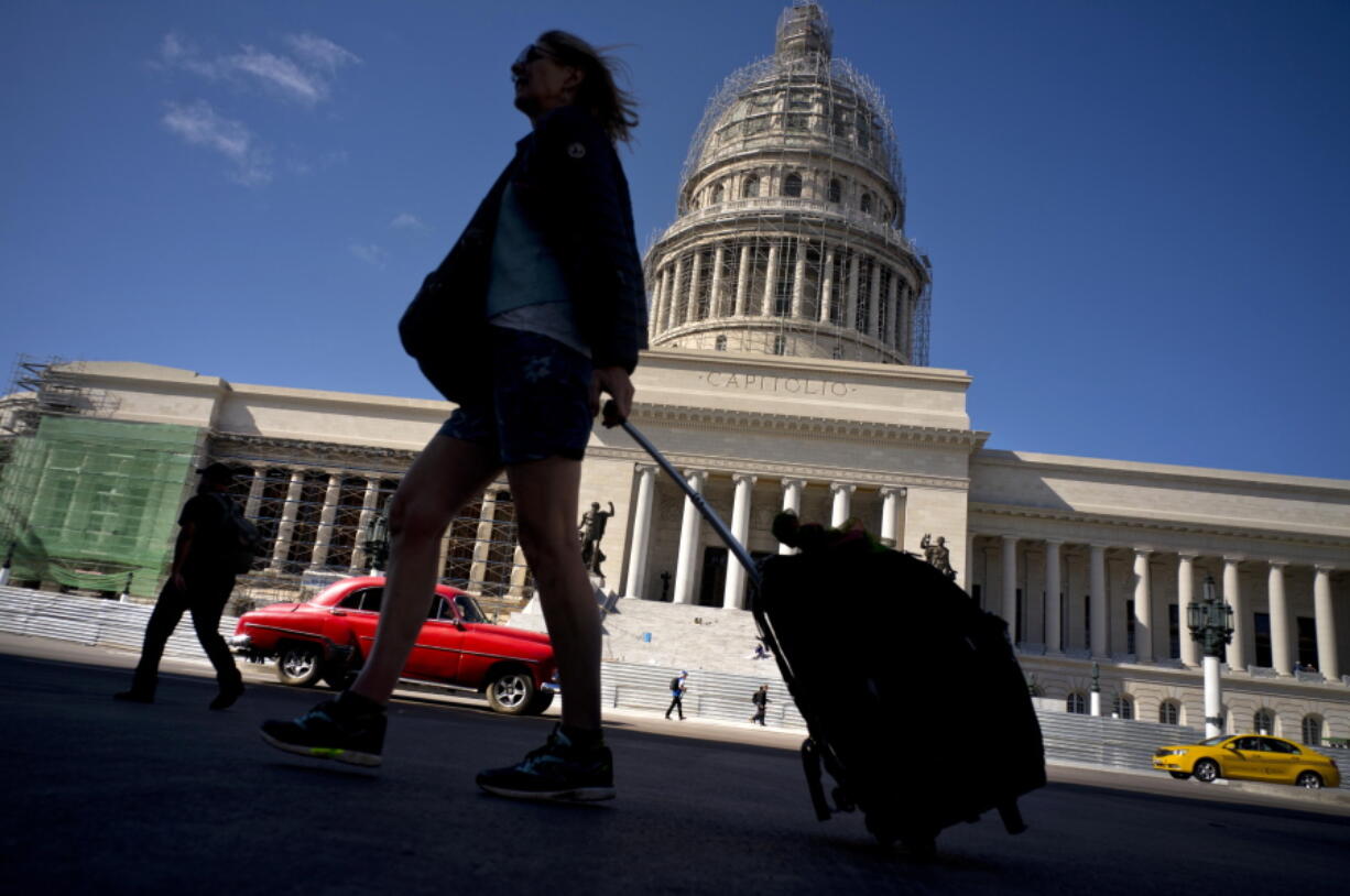 A tourist walks in front of the Capitolio on Thursday in Havana, Cuba.