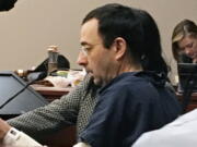 Former Michigan sports doctor Larry Nassar sits in court Tuesday in Lansing, Mich., at the start of his four-day sentencing hearing for sexually assaulting young gymnasts. Dozens of women and girls who were victims will be allowed to speak. Judge Rosemarie Aquilina is expected to order a sentence Friday, Jan. 19.