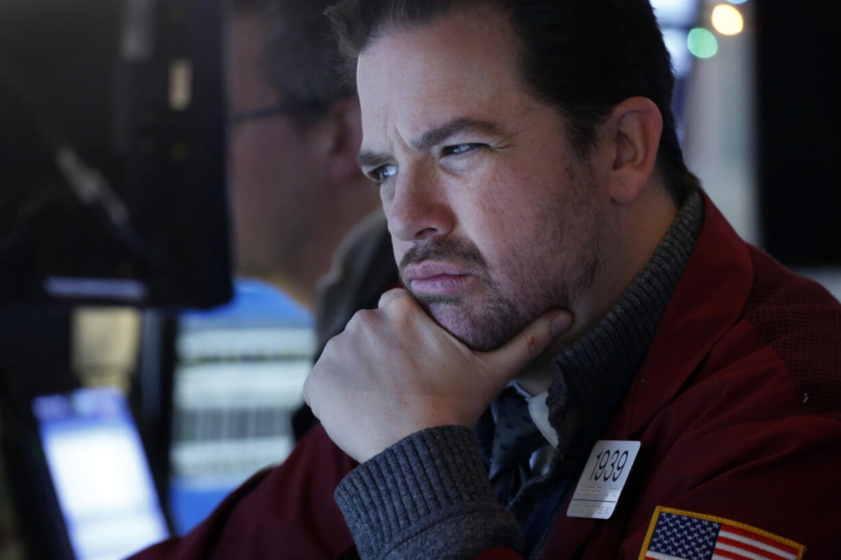 Stock trader Chris Lotito studies a computer screen at the New York Stock Exchange, Tuesday, Jan. 2, 2018.