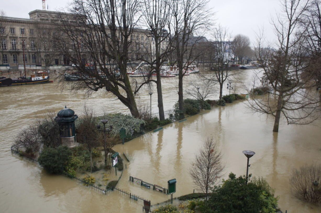 A flooded public park is pictured Tuesday in Paris. The Seine River has overflowed its banks in Paris, prompting authorities to close several roads and cancel boat cruises. Paris City Hall closed roads along the shores of the Seine from the east of the capital to the area around the Eiffel Tower in the west as water levels rose nearly 11 feet above the normal level.