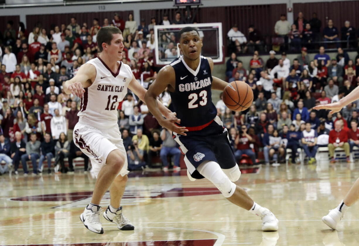 Gonzaga guard Zach Norvell Jr. (23) dribbles next to Santa Clara guard Matt Hauser (12) during the second half of an NCAA college basketball game Saturday, Jan. 20, 2018, in Santa Clara, Calif.