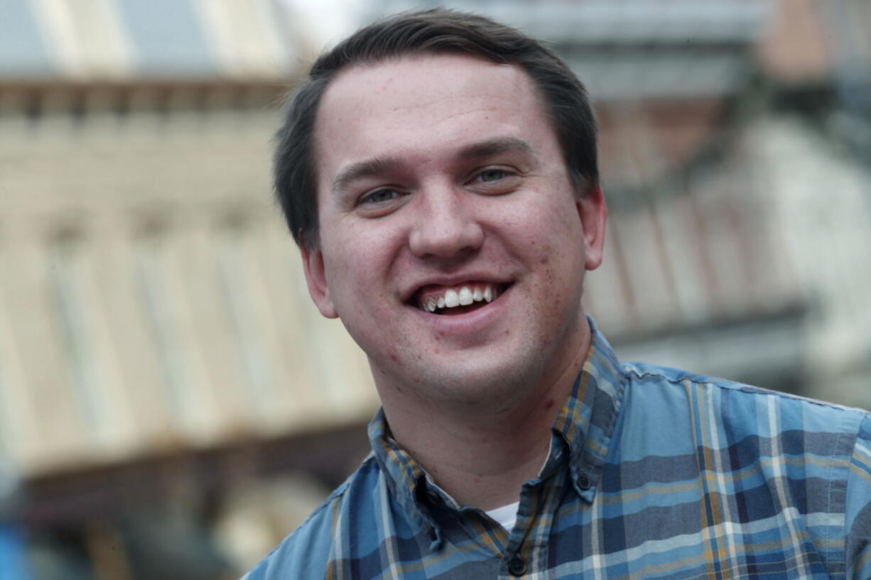 27-year-old Caleb Jackson of Greeley, Colo., is shown Jan. 18 outside a classroom building of the University of Colorado by Larimer Square in lower downtown Denver. Jackson, who has a neurological condition covered by the Affordable Care Act, is a graduate student in urban and regional planning at the Denver campus. Officials in several of the 11 states and the District of Columbia that run their own health care exchanges are reporting strong enrollments this year despite shortened sign-up periods, higher premiums and repeated efforts by Republicans in Washington to repeal the Affordable Care Act, which is helping people such as Jackson.