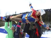 United States’ Julia Mancuso is celebrated by members of the US ski team at the end of an alpine ski, women’s World Cup downhill, in Cortina D’Ampezzo, Italy, Friday, Jan.19, 2018.