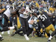 Jacksonville Jaguars running back Leonard Fournette (27) runs the ball against the Pittsburgh Steelers during the second half of an NFL divisional football AFC playoff game in Pittsburgh, Sunday, Jan. 14, 2018.