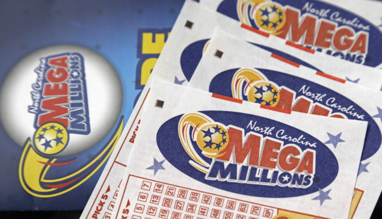 FILE - In this July 1, 2016, file photo, Mega Millions lottery tickets rest on a counter at a Pilot travel center near Burlington, N.C. The jackpot for the Mega Millions lottery game has climbed to over $450 million, just hours before the drawing, Friday, Jan. 5, 2018.