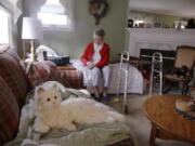 In this Friday Dec. 1, 2017, photo, 93-year-old Mary Derr sits on her bed near her robot cat she calls “Buddy” in her home she shares with her daughter Jeanne Elliott in South Kingstown, R.I. Buddy is a Hasbro’s “Joy for All” robotic cat, aimed at seniors and meant to act as a “companion,” it has been on the market for two years. Derr has mild dementia, and Elliott purchased a robot earlier this year to keep her mother company.