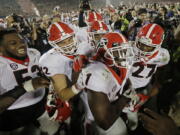 Georgia tailback Sony Michel (1) celebrates with teammates after scoring the game-winning touchdown in the second overtime period to give Georgia a 54-48 win over Oklahoma in the Rose Bowl NCAA college football game, Monday, Jan.