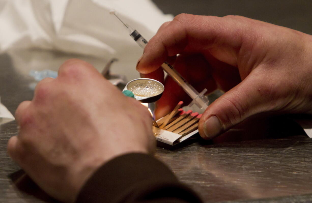 A man prepares heroin he bought on the street to be injected at the Insite safe injection clinic in Vancouver, B.C. As part of Philadelphia’s effort to combat skyrocketing opioid overdoses, city officials announced Tuesday they want to establish safe havens where people can inject drugs, after members of the city’s opioid task force visited Seattle and Vancouver in 2017.