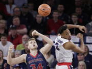 Saint Mary’s center Jock Landale (34) and Gonzaga forward Johnathan Williams go after the ball during the first half of an NCAA college basketball game in Spokane, Wash., Thursday, Jan. 18, 2018.