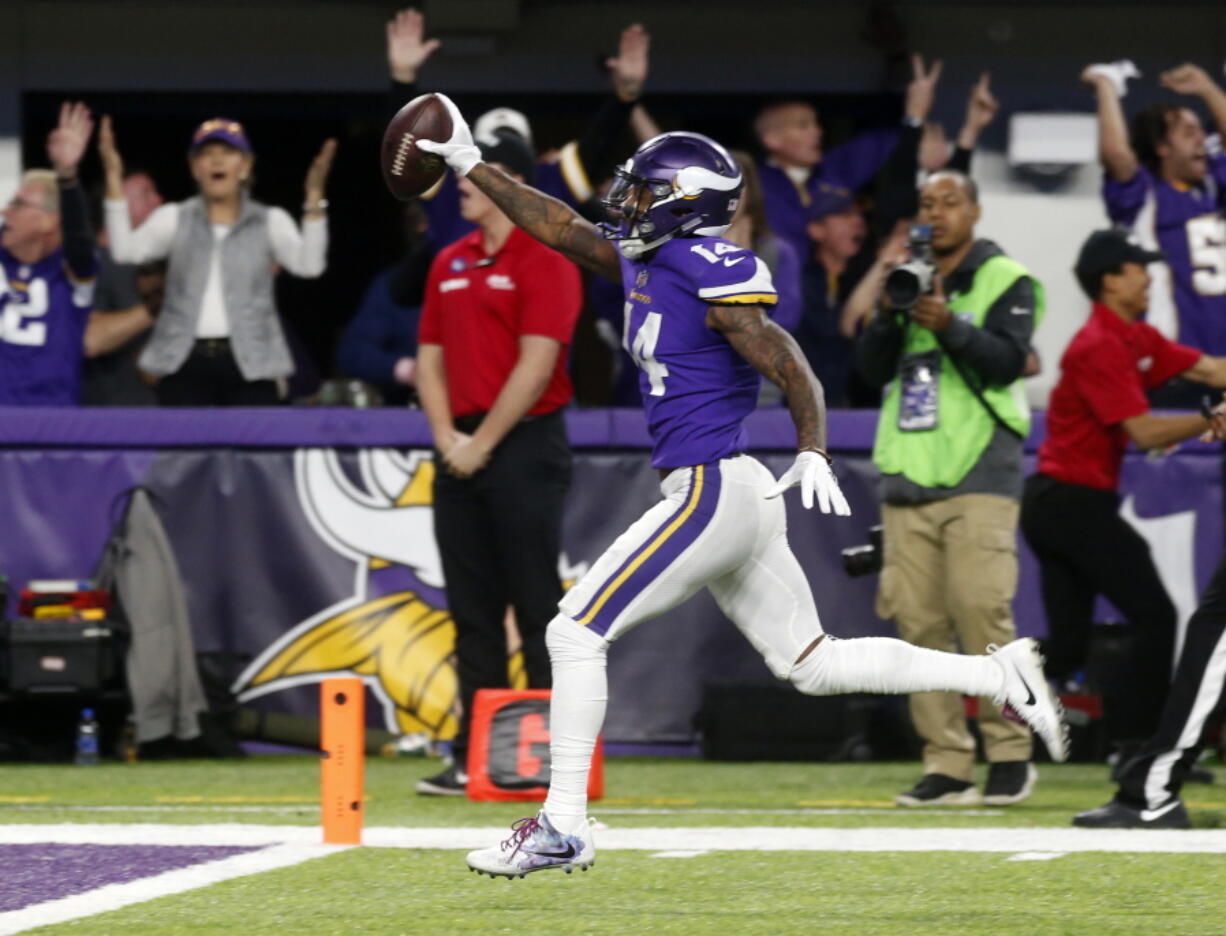 Minnesota Vikings wide receiver Stefon Diggs (14) runs in for a game winning touchdown against the New Orleans Saints during the second half of an NFL divisional football playoff game in Minneapolis, Sunday, Jan. 14, 2018.