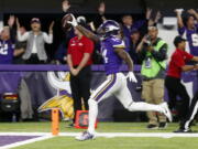 Minnesota Vikings wide receiver Stefon Diggs (14) runs in for a game winning touchdown against the New Orleans Saints during the second half of an NFL divisional football playoff game in Minneapolis, Sunday, Jan. 14, 2018.