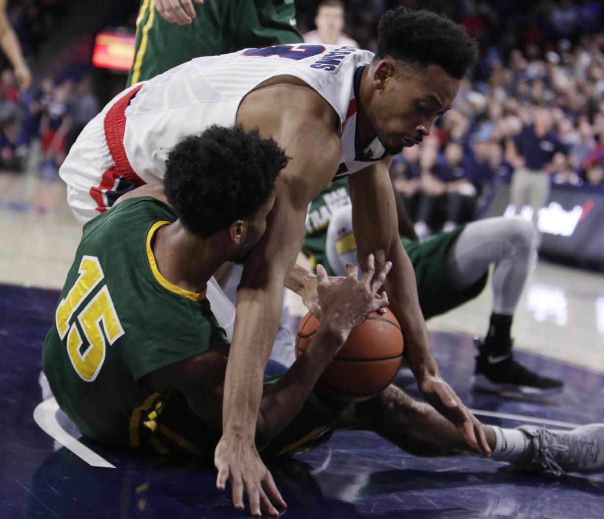 San Francisco forward Nate Renfro (15) and Gonzaga forward Johnathan Williams go after the ball during the first half of an NCAA college basketball game in Spokane, Wash., Saturday, Jan. 27, 2018.