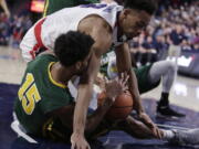 San Francisco forward Nate Renfro (15) and Gonzaga forward Johnathan Williams go after the ball during the first half of an NCAA college basketball game in Spokane, Wash., Saturday, Jan. 27, 2018.