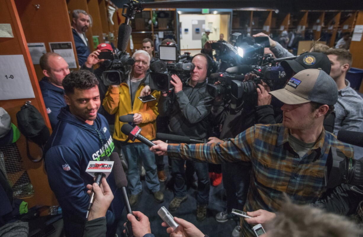 Seahawks quarterback Russell Wilson answers questions a day after the last game of the season in the Seahawks locker room as other players clean out their lockers on Monday, Jan. 1, 2018.