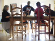 Artist and author Maybeth Morales, left, leads a home school art class Friday for her grandchildren as her daughter Chemay Morales-James, right, and son-in-law Shane, center, watch in Watertown, Conn.