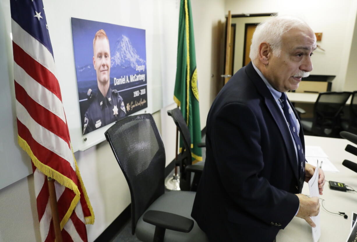 Pierce County Sheriff Paul Pastor stands up after speaking Wednesday, Jan. 10, 2018, during a news conference to update reporters on the status of the investigation into the fatal shooting of Deputy Daniel McCartney earlier in the week. (AP Photo/Ted S.