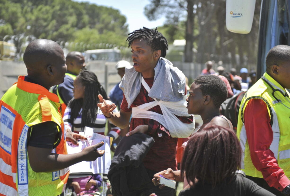 An injured passenger receives attention at the scene of a train accident near Kroonstad, South Africa, Thursday, Jan 4, 2018. South Africa’s transport minister says at least 12 people died and more than 260 were injured in a collision between a truck and a passenger train.