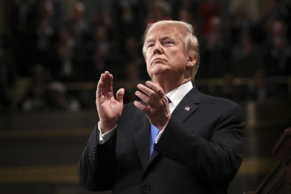 President Donald Trump claps during the State of the Union address in the House chamber of the U.S. Capitol to a joint session of Congress Tuesday, Jan. 30, 2018 in Washington.