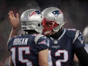 New England Patriots quarterback Tom Brady, right, celebrates his touchdown pass to Chris Hogan during the first half of an NFL divisional playoff football game against the Tennessee Titans, Saturday, Jan. 13, 2018, in Foxborough, Mass.