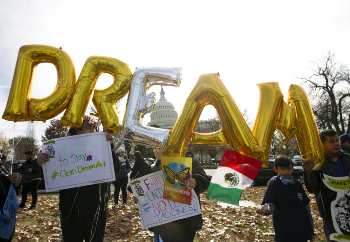 Demonstrators hold up balloons Dec. 6 during an immigration rally in support of the Deferred Action for Childhood Arrivals (DACA), and Temporary Protected Status (TPS), programs, near the U.S. Capitol in Washington. Casting a cloud over already tenuous negotiations, President Donald Trump said Sunday that DACA, a program that protects immigrants who were brought to the U.S. as children and live here illegally, is “probably dead” and blamed Democrats, days before some government functions would start shutting down unless a deal is reached.