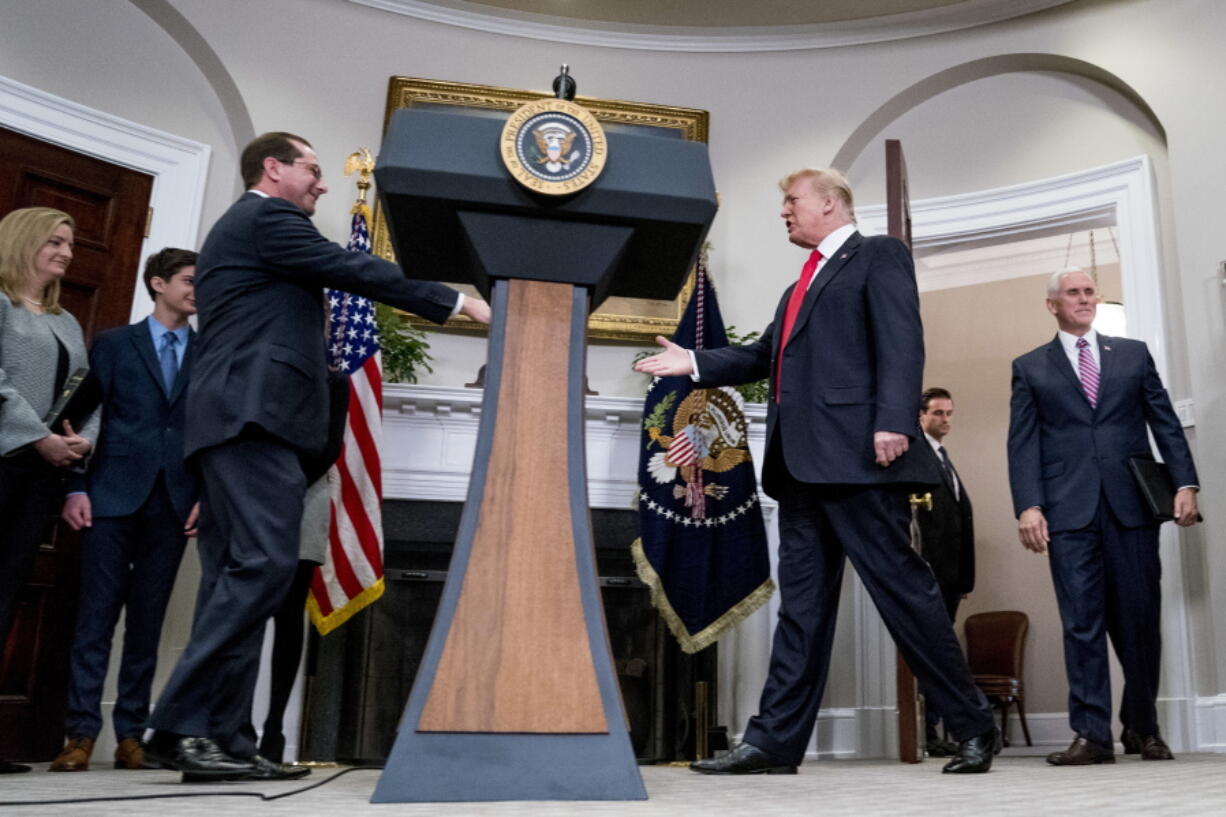 President Donald Trump, center right, and Vice President Mike Pence, right, arrive for a swearing in ceremony for Health and Human Services Secretary Alex Azar, third from left, in the Roosevelt Room at the White House, Monday, Jan. 29, 2018, in Washington.