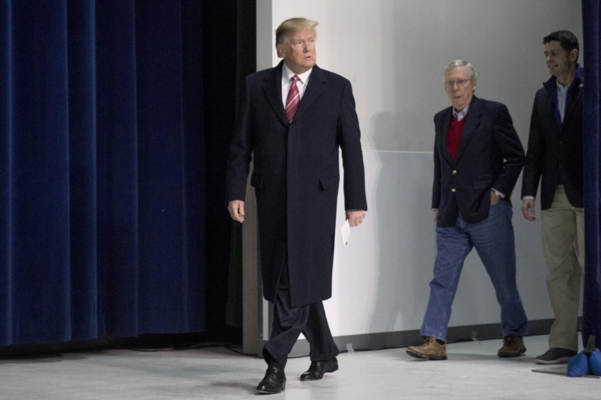 President Donald Trump, left, accompanied by Senate Majority Leader Mitch McConnell of Ky., second from right, and House Speaker Paul Ryan of Wis., right, arrives for a news conference after participating in a Congressional Republican Leadership Retreat at Camp David, Md., Saturday.