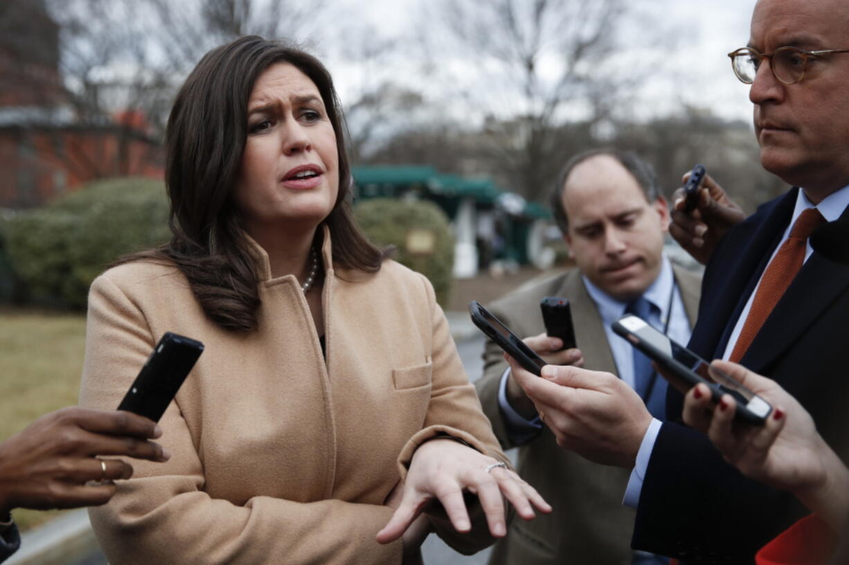 White House press secretary Sarah Huckabee Sanders talks to media outside the White House in Washington during a government shutdown Monday.