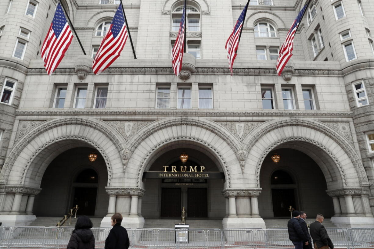 FILE- In this Dec. 21, 2016, file photo, the Trump International Hotel in Washington is shown. A federal judge in Maryland hints that a recent New York court ruling might not sway him from considering whether President Donald Trump’s business empire violates the emoluments clause of the Constitution.