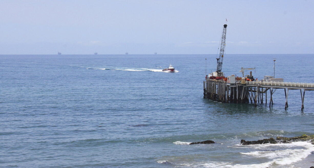 FILE- This May 16, 2015, file photo shows oil drillings offshore of a service pier in the Santa Barbara Channel off the coast of Southern California near Carpinteria. Opposition to the Trump administration’s plan to expand offshore drilling mounted Wednesday, Jan. 10, 2018. The plan could open up federal waters off the California coast for the first time in more than three decades. The Channel is one of those areas that could open up.