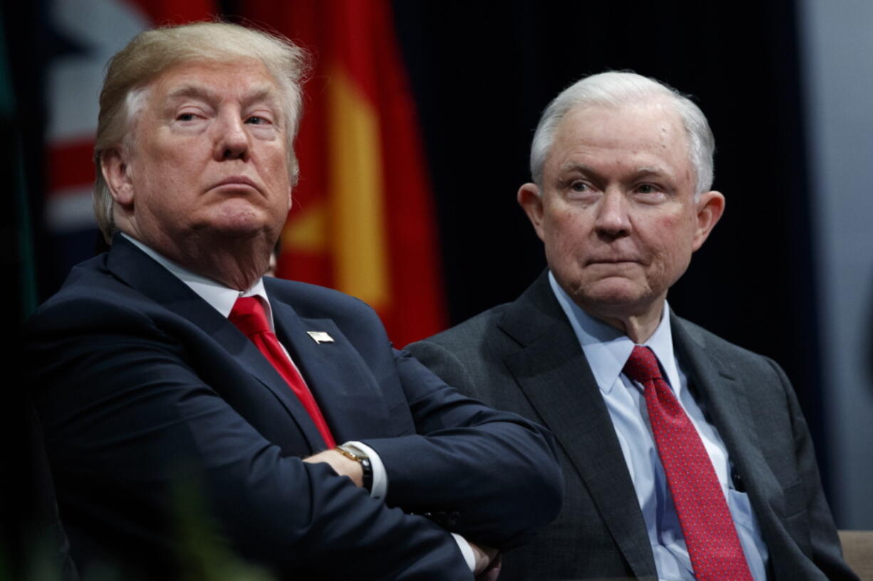 FILE - In this Dec. 15, 2017, file photo, President Donald Trump sits with Attorney General Jeff Sessions during the FBI National Academy graduation ceremony in Quantico, Va. Trump’s White House counsel personally lobbied Attorney General Jeff Sessions to not recuse himself from the Justice Department’s investigation into potential ties between Russia and the Trump campaign.