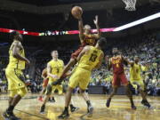 Southern California’s Jordan McLaughlin drives to the basket against Oregon players, including MiKyle McIntosh, left, Payton Pritchard and Paul White (13), with USC’s Chimezie Metu and Oregon’s Troy Brown Jr. watching at right during the second half of an NCAA college basketball game Thursday, Jan. 18, 2018, in Eugene, Ore. Referees first called a foul on White, but reversed the call to a player control foul on McLaughlin.