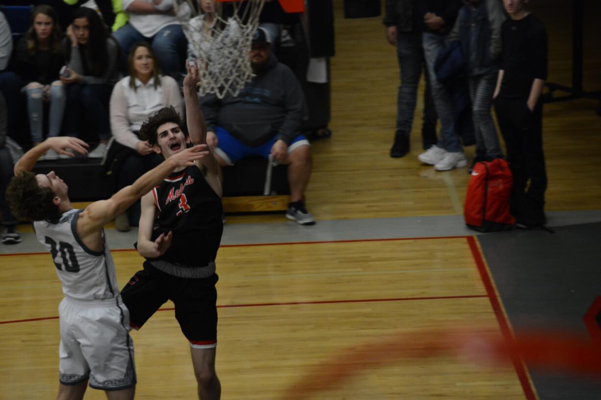 Jackson Glikbarg (3) finishes a layup with his left hand past Union's Quinn Lamey (20) during Union's 73-61 win on Friday, Jan.