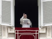 Pope Francis recites the Angelus noon prayer from the window of his studio overlooking St. Peter’s Square at the Vatican on Sunday.