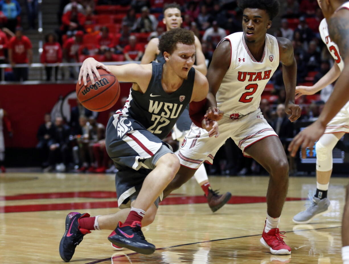 Washington State guard Malachi Flynn (22) drives as Utah guard Kolbe Caldwell (2) defends in the first half during an NCAA college basketball game Sunday, Jan. 21, 2018, in Salt Lake City.